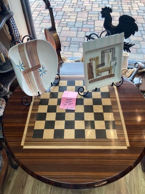 Among ornaments and home decor is a vintage art deco chess board. 