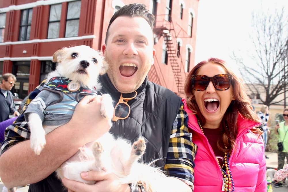 Parade participants posing with their dog