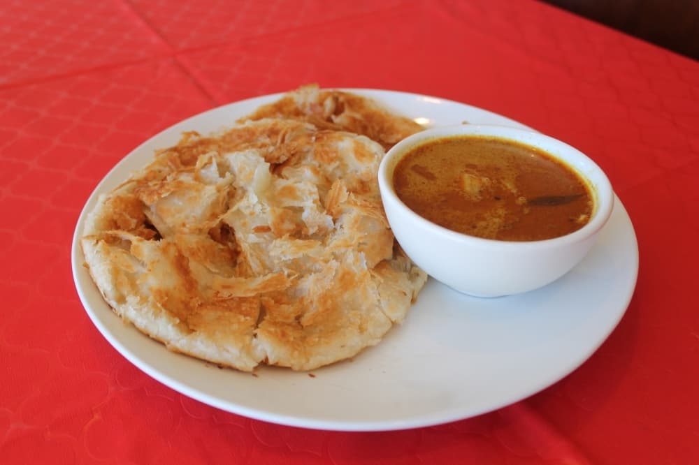 Malaysian Roti Canai ($6.99) is Malaysian-Indian flatbread cooked on a skillet and served with curry chicken dipping sauce.