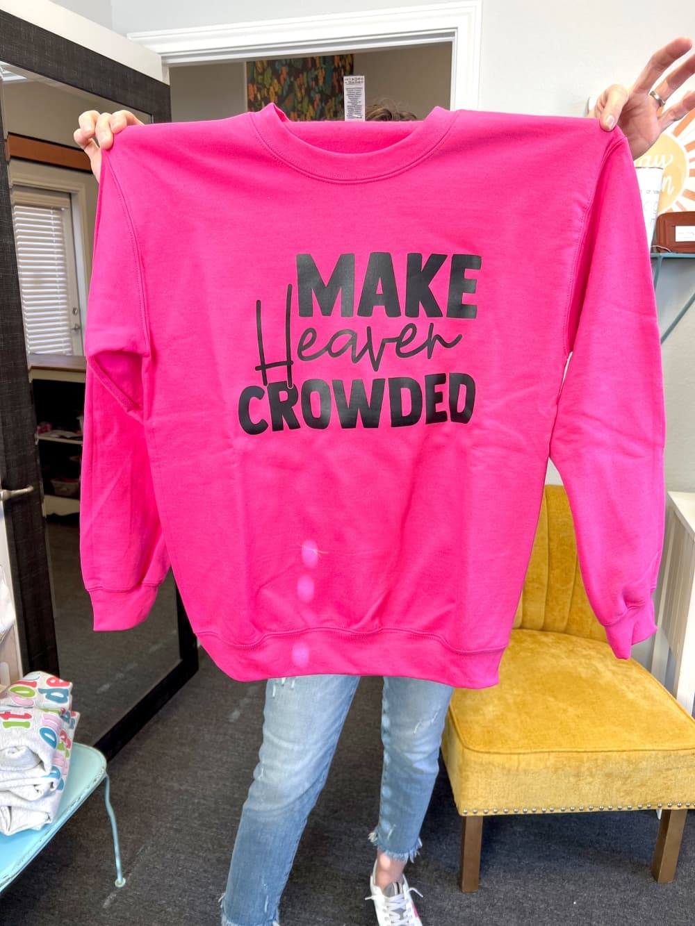 pink sweatshirt with black text that reads "make heaven crowded"