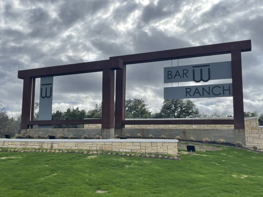 sign welcoming residents and guests into the neighborhood