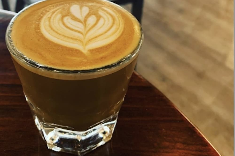 A glass cup with latte art. 