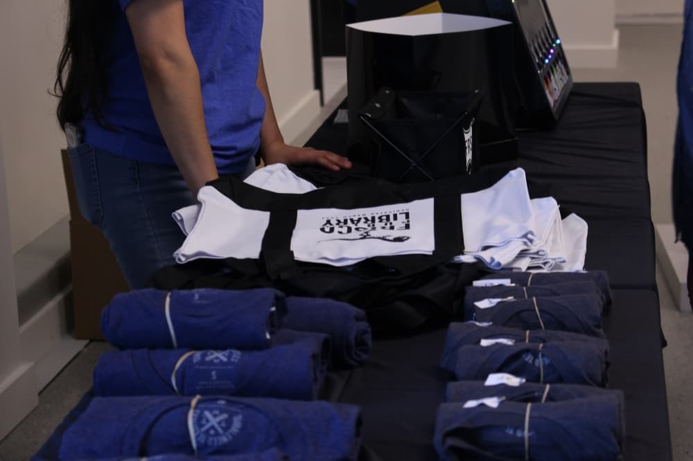 A table full of free gifts were available to attendees of the grand opening. (Alex Reece/Community Impact)
