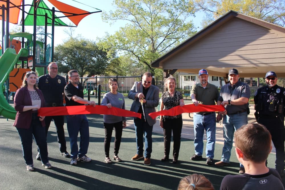 From left, Christy Miller, Police Chief Tom Libby, Council Members Alex Jones and Frances Planchard, Mayor Paul Bond, Council Members Dawn Candy and Clint McClaren, and Public Works Director James Corn attend a ribbon-cutting for the park. (Jessica Shorten/Community Impact)