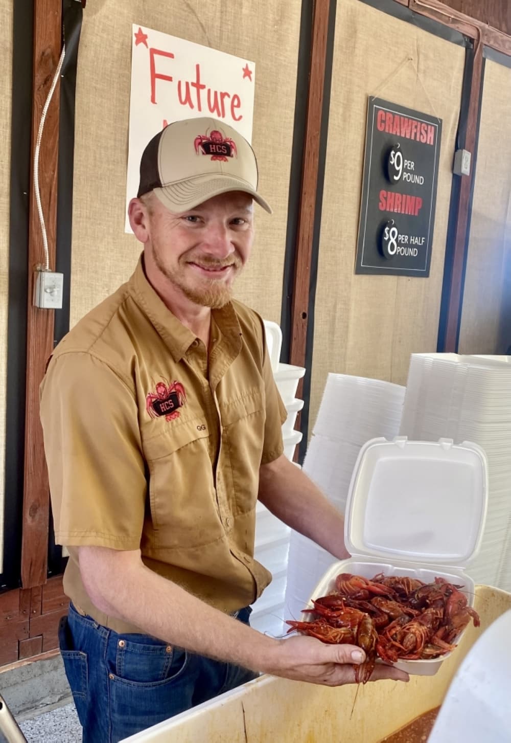 
Hans Stevens packages up fresh crawfish from the cooler at the start of the season in Tomball.
