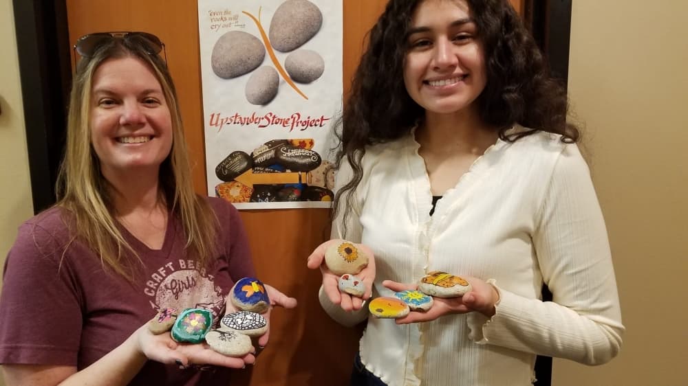 Members of the Holocaust Remembrance Association in Kingwood showcase the nonprofit's Upstanding Stone Project, which features stones painted by individuals, families and volunteers from other groups throughout Texas that will be placed in the nonprofit's Holocaust Garden of Hope. (Courtesy Holocaust Remembrance Association)