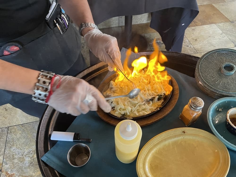 Step 4: After stirring, pour oil on the  Flameado and light it on fire. (Taylor Cripe/Community Impact) 