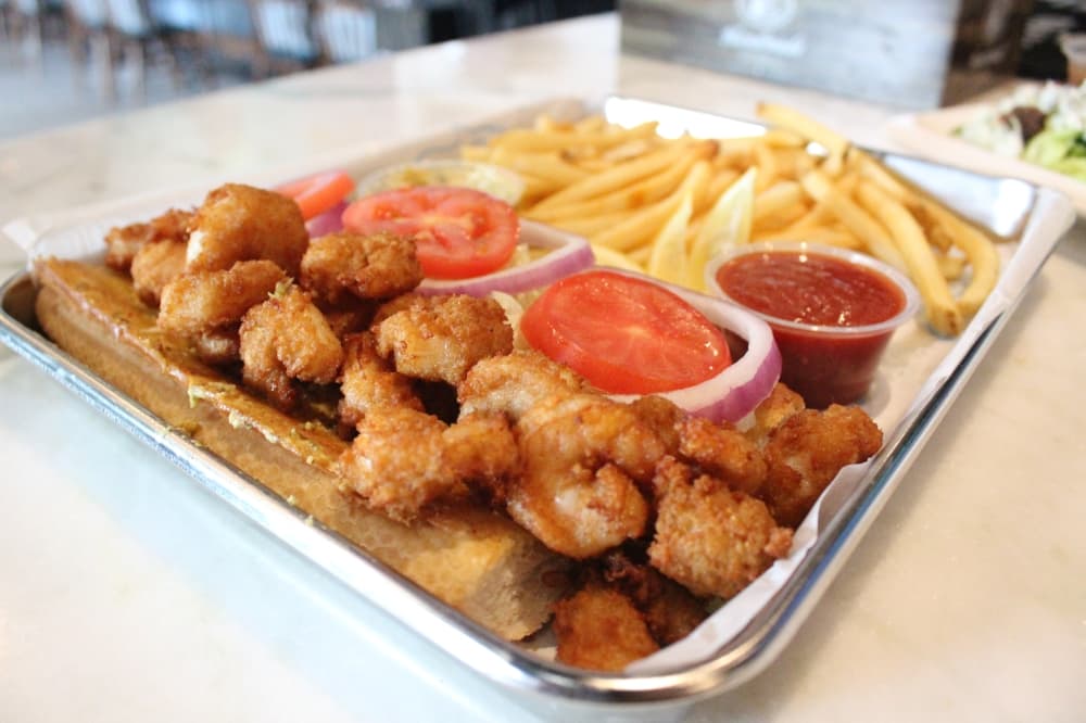 The Pipeline fried shrimp Po-Boy ($12.99) A fried shrimp sandwich smothered in remoulade sauce and topped with lettuce, sliced tomatoes and red onions. Served with fries. (Emily Lincke/Community Impact)