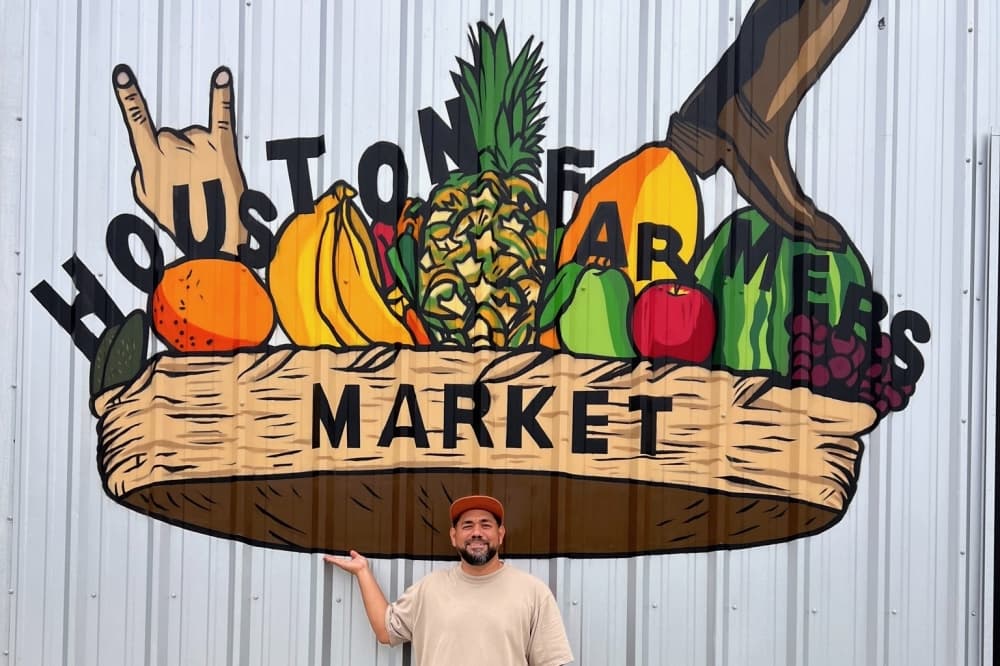Visual artists and muralist DonkeeBoy poses in front of his new interactive mural at the Houston Farmers Market. The mural pays tribute to the types of produce seen at the market as well as the cultures of Texas and Mexico. (Courtesy DonkeeBoy)
