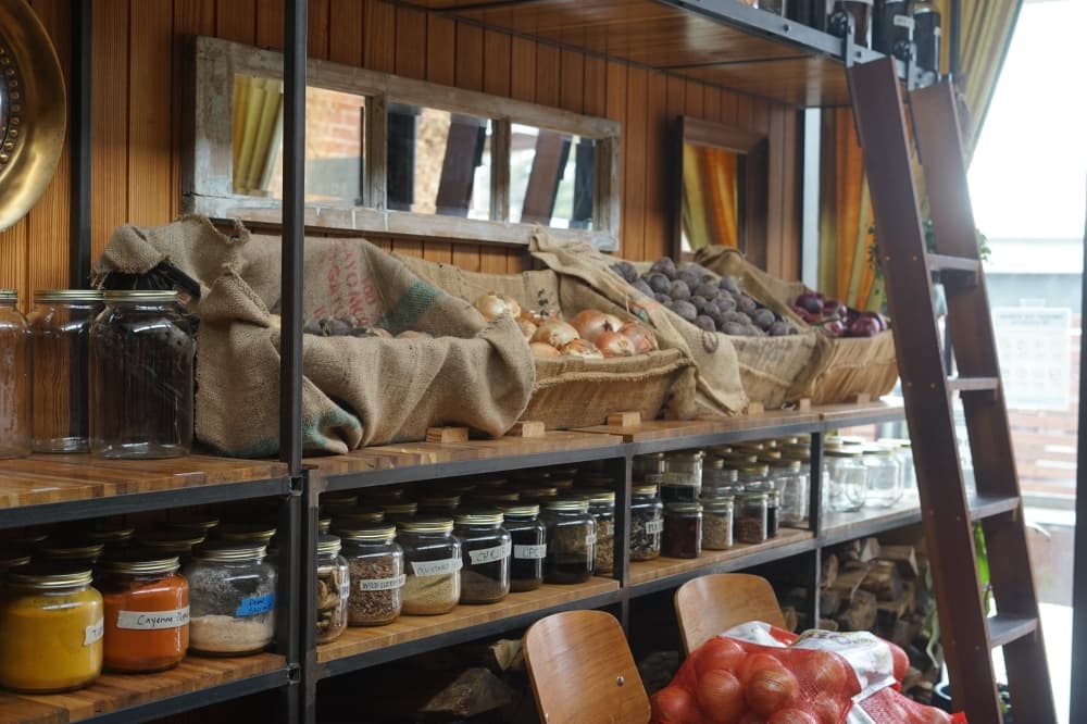 open shelving at the restaurant is stocked with baskets of onions and potatoes