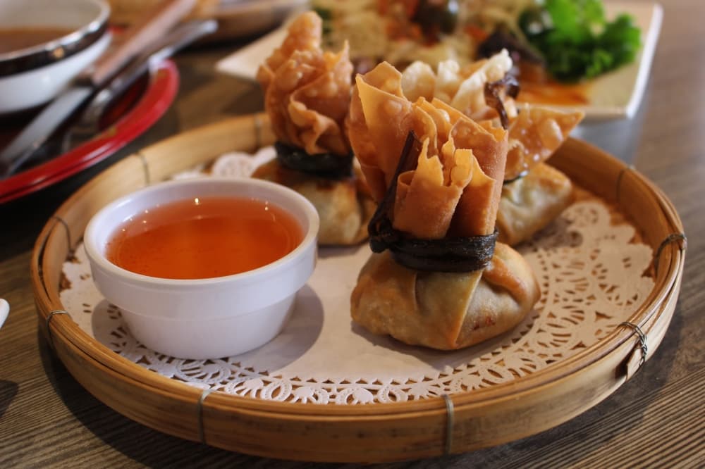 The stuffed sachets ($6) are made with chicken or pork and accompanied by a plum sauce. (Jessica Shorten/Community Impact)