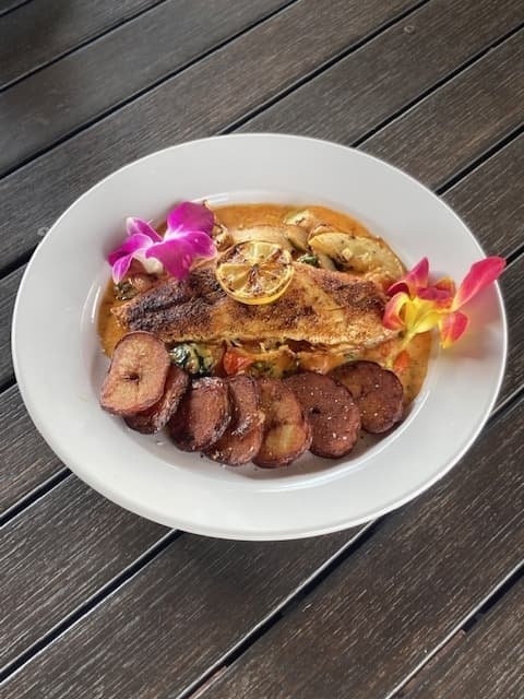 Redfish ($22) is served with roasted red potatoes and a cherry tomato wine sauce.