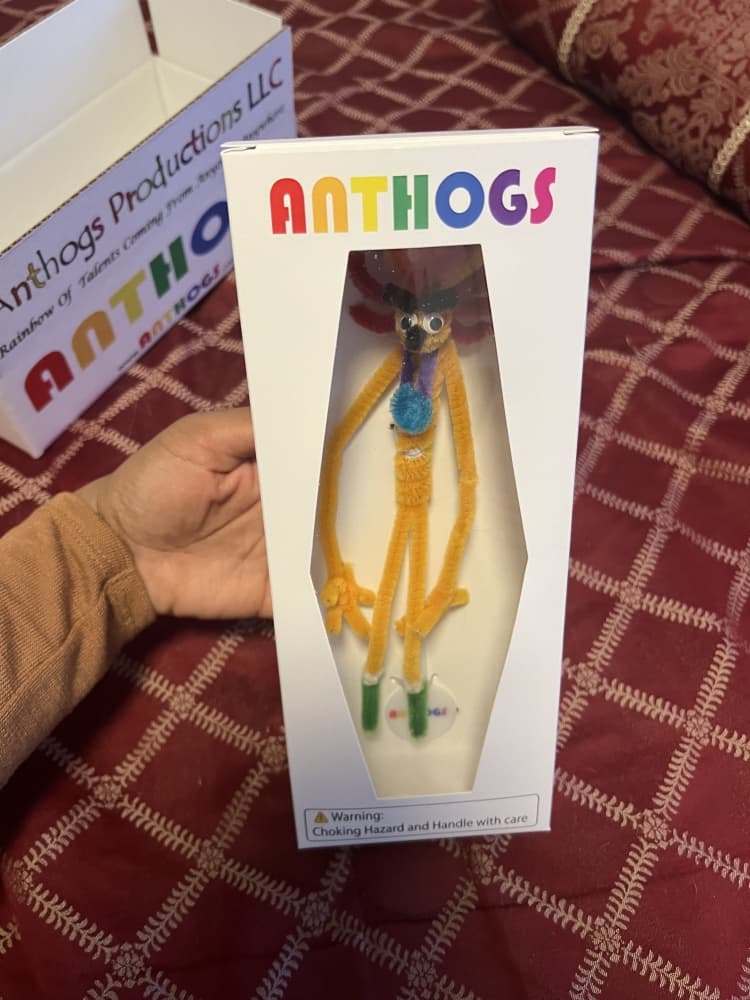 orange pipe cleaner person in white box with anthogs logo 