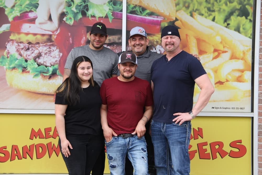 Owners Robert Headley (right) and Cesar Sanchez (front center) opened Mean Burger in March 2022.