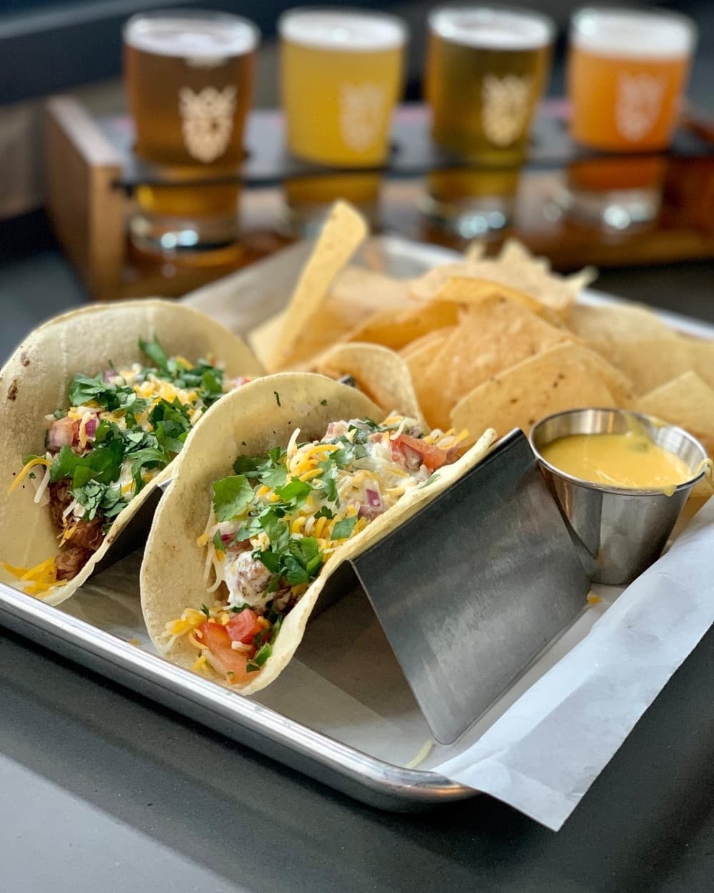 Pulled pork tacos ($14.50) are topped with pico, cilantro, cheese, BBQ sauce and cilantro mayo. (Courtesy Paradigm Brewery)
