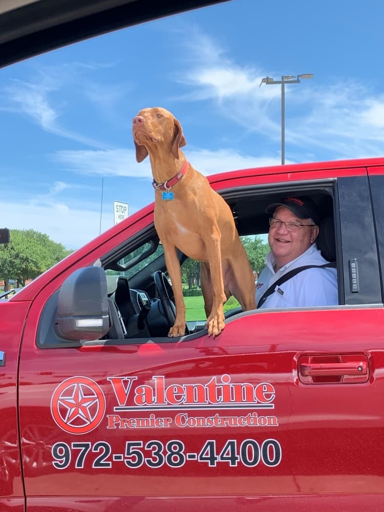 A man in his red truck. 