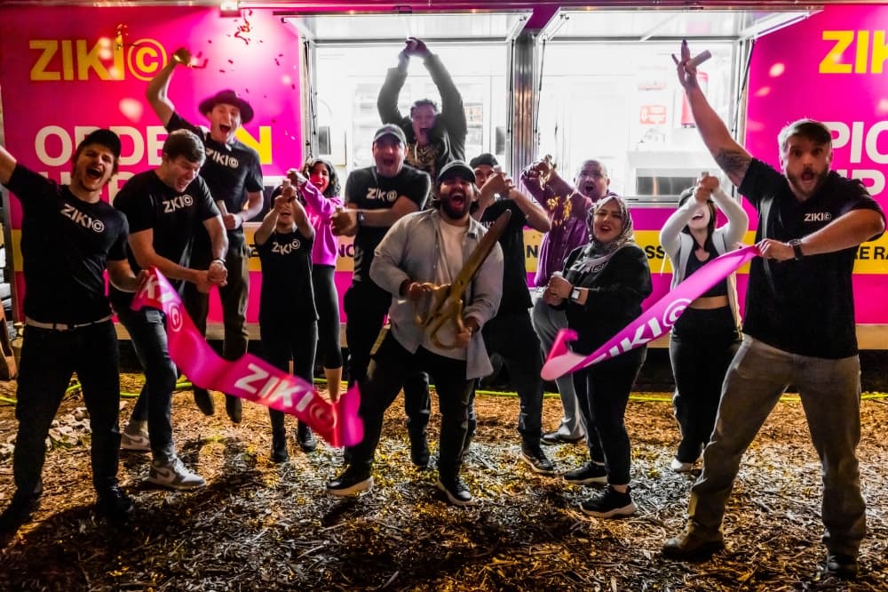 people celebrating food truck with ribbon cutting 