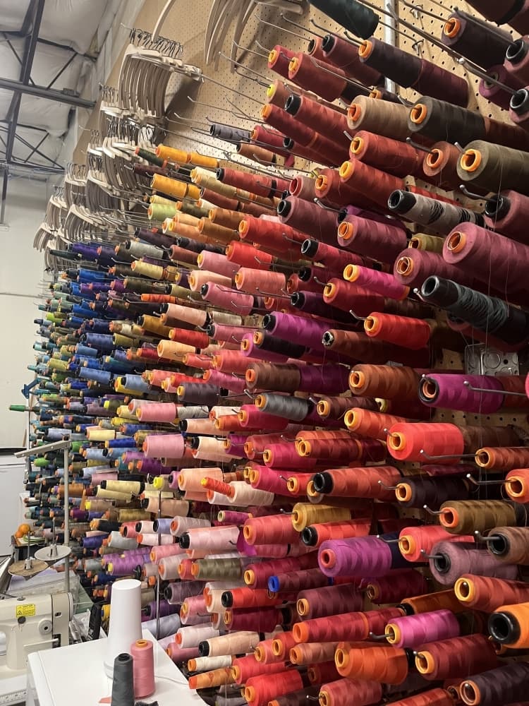 Rolls of fabric from warm reds and pinks to cool blues 