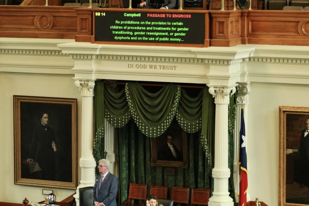 A screen in the Texas Senate chamber reads 'SB 14, Campbell, passage to engross. Re: prohibitions on the provision to certain children of procedures and treatments for gender transitioning, gender reassignment, or gender dysphoria and on the use of public money...'
