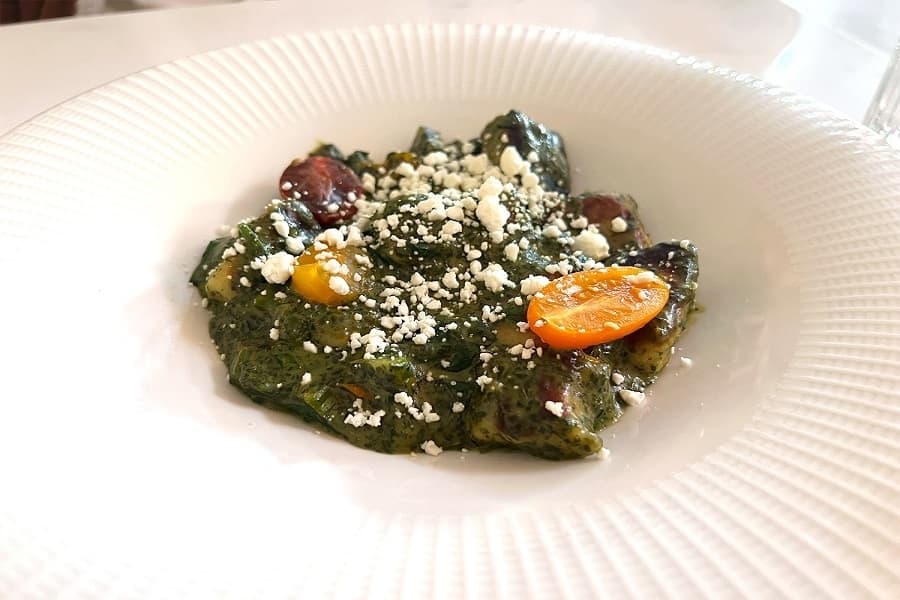 potato gnocchi topped with pesto, goat cheese and veggies 
