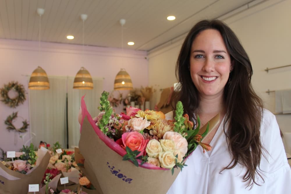 Owner holding bouquet of flowers