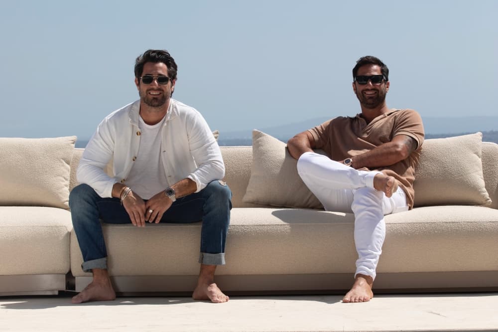 Habour founders, brothers Nicholas and Harrison Condos, pose on an Amalfi sofa. (Courtesy Harbour)
