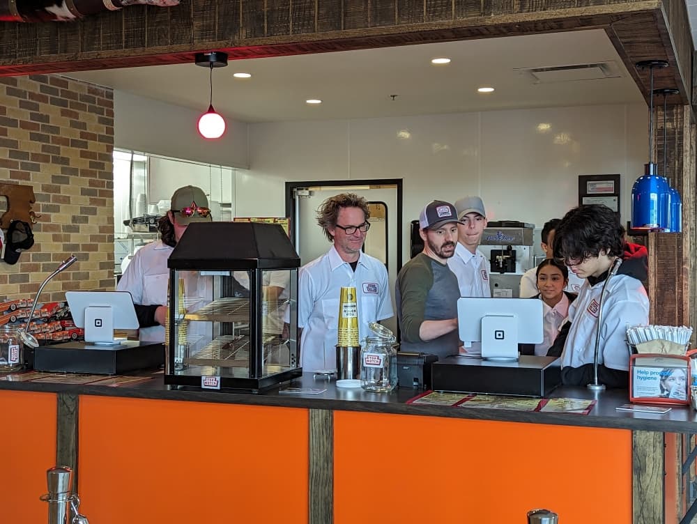 Owner Kelly Chappell trains employees ahead of Top Notch's opening. (Carson Ganong/Community Impact)