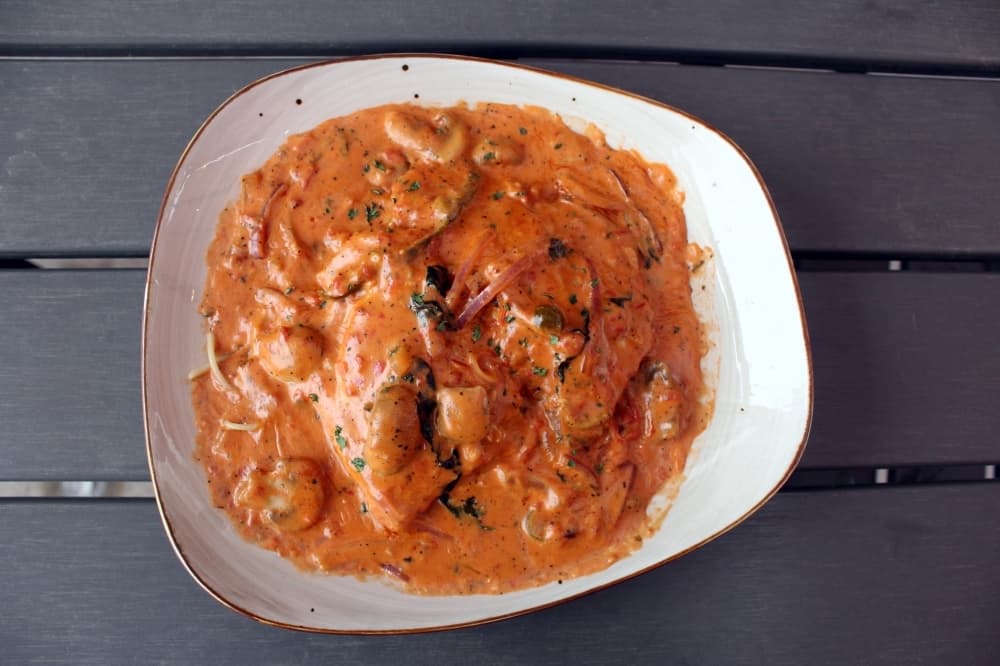 A bowl of pasta with red sauce