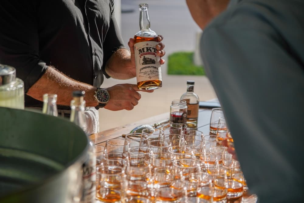 Someone holding a bottle of whiskey