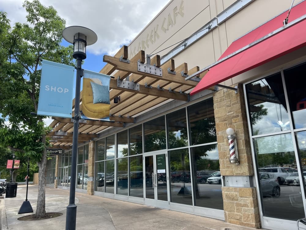 shopping center storefront with "the shops at arbor walk" sign