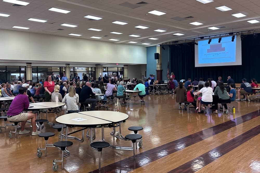 The cafeteria at Creekside Park Junior High filled with parents and community members. 
