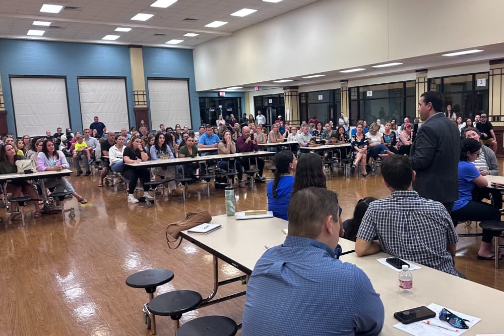 Board Secretary Justin Unser speaks to town hall attendees. 