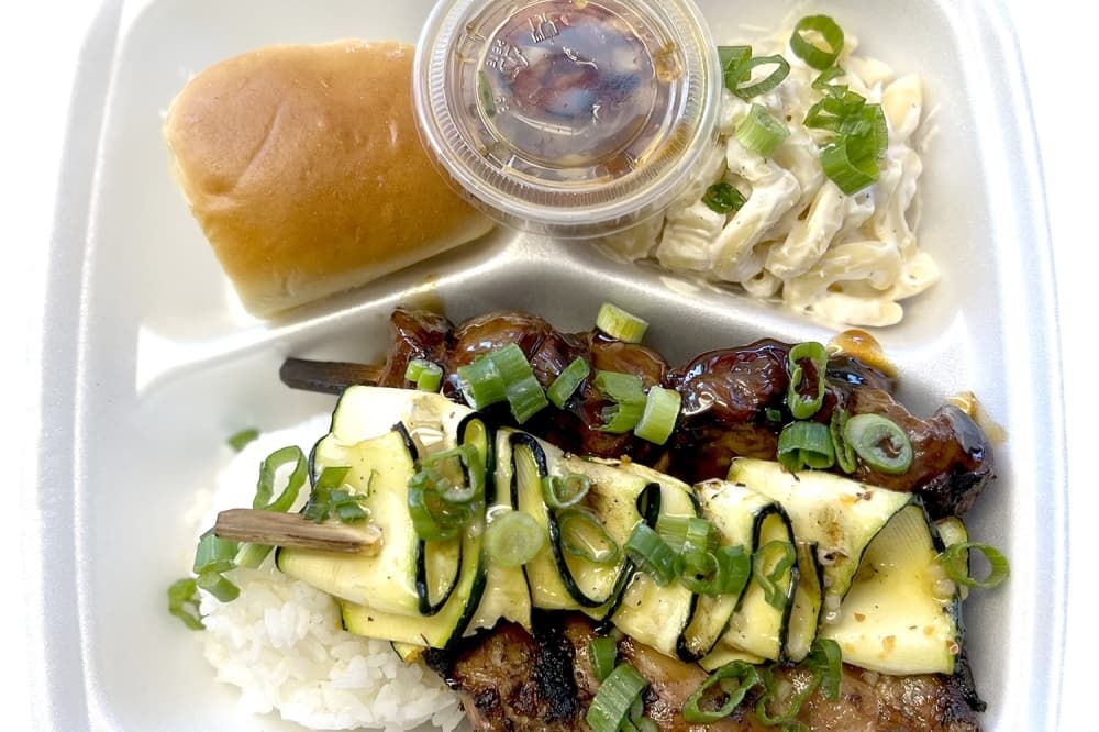 A Plate No. 2 with shoyu chicken, teriyaki beef sirloin skewer, white rice, grilled zucchini, mac salad, Hawaiian roll and finadene sauce. (Zacharia Washington/Community Impact)