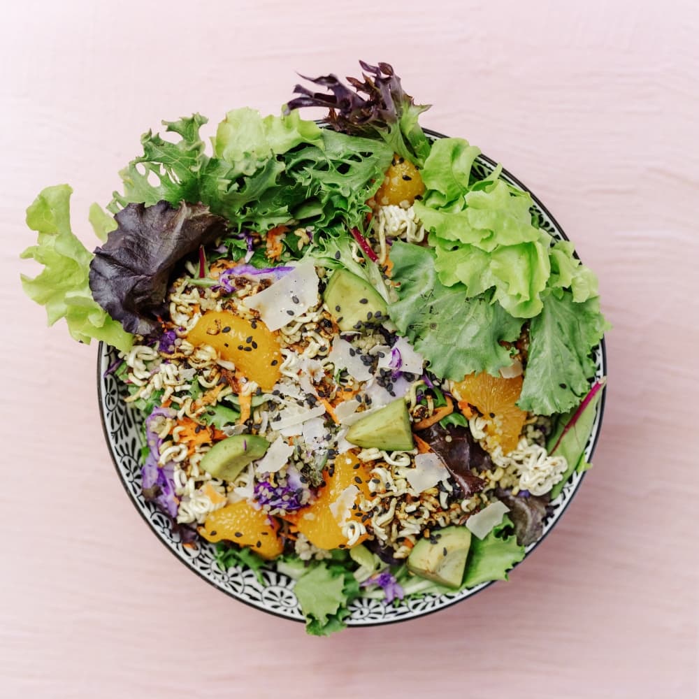 The La Clementine ($12.95) features romaine lettuce, mixed greens, mandarin oranges, carrot, avocado, purple cabbage, crispy ramen, manchego cheese and sesame seeds. (Courtesy Juicepop & More)