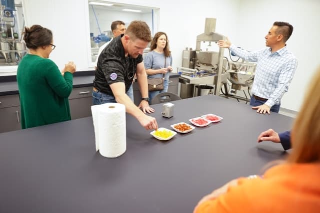 Man reaching for piles of gummies on a plate