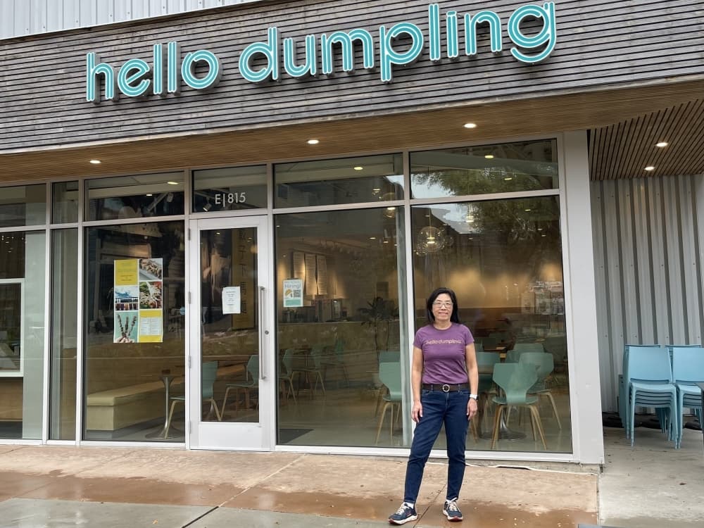June Chow stands in front of the hello dumpling building
