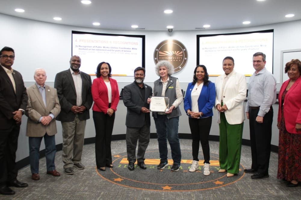 The Missouri City Council presented former employee Millie Holifield (center) with a certificate for her 33 years of service. (Jack Dowling/Community Impact)