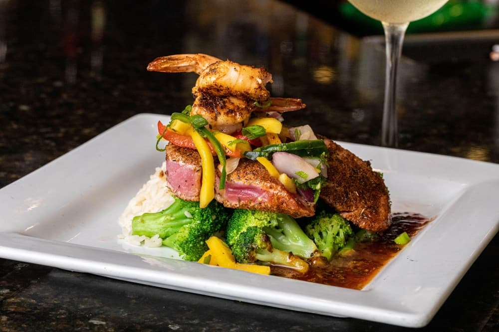 image of tune stacked with blackened shrimp and seasonal vegetables