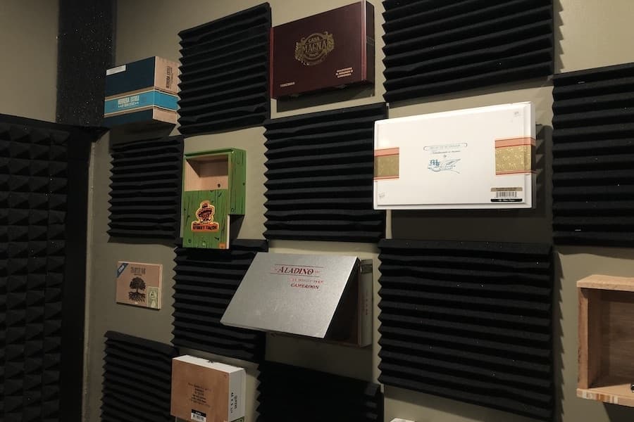 The studio walls are decorated with old cigar boxes and photos of local artists. (Amira Van Leeuwen/Community Impact)