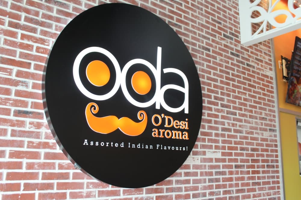 O'Desi Aroma sign on a brick wall