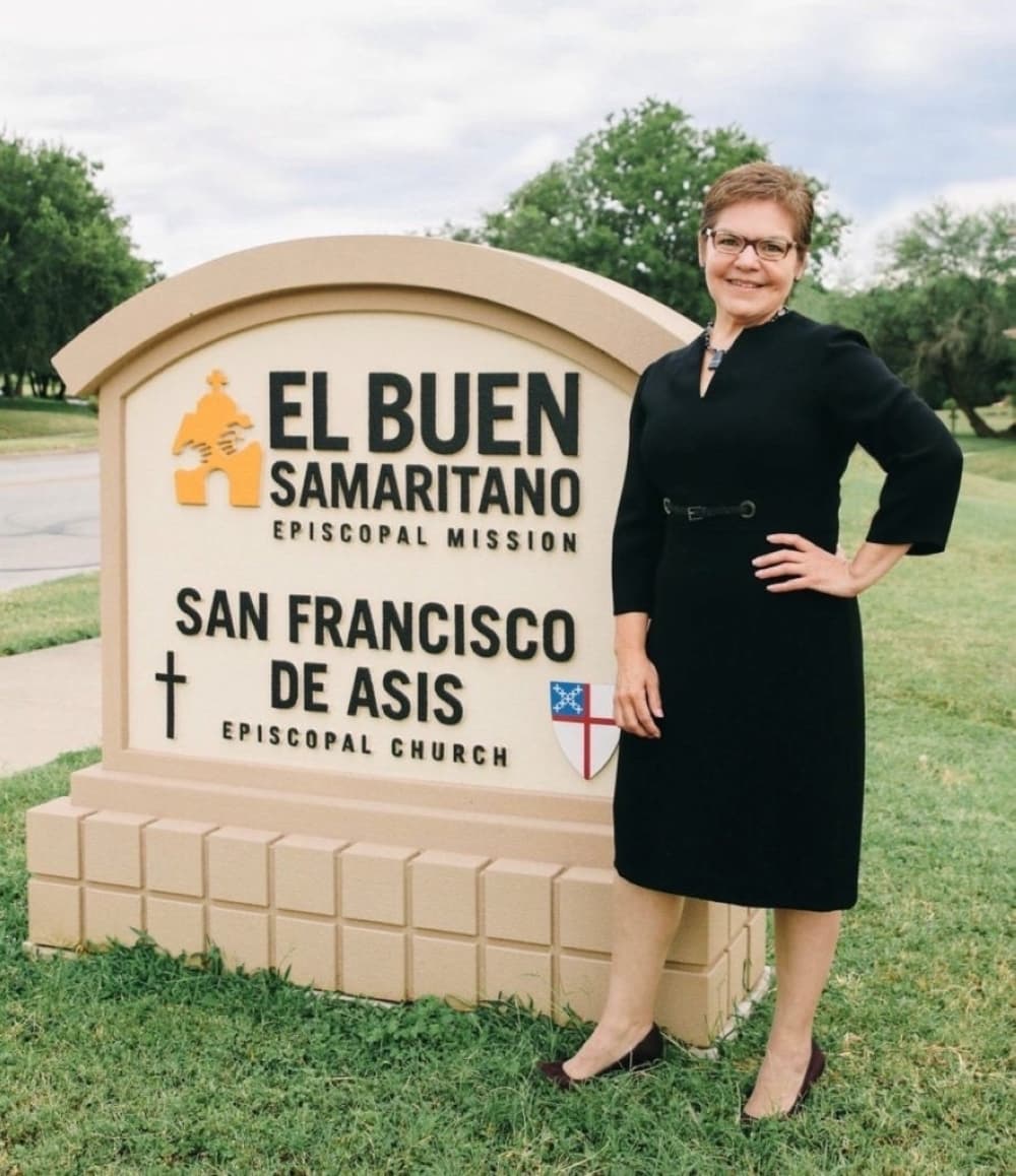 woman standing by nonprofit sign outside