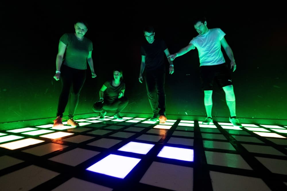 people walking on lit up tiles