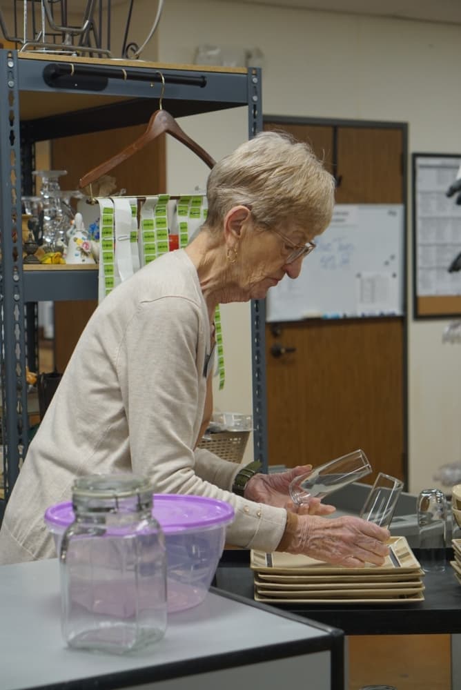 Volunteer Joan Sullivan is in charge of sorting through houseware at the thrift store. (Cassandra Jenkins/Community Impact)