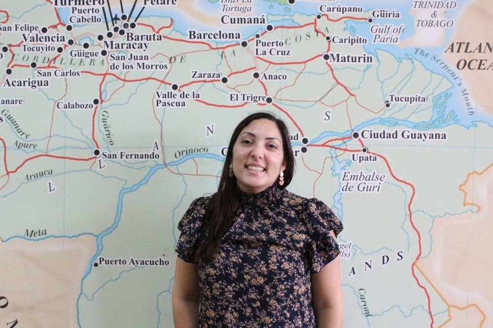 Owner standing in front of a map