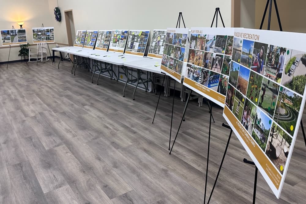 Posters of Tomball's parks and concept imagery line the wall at the Tomball Community Center. 