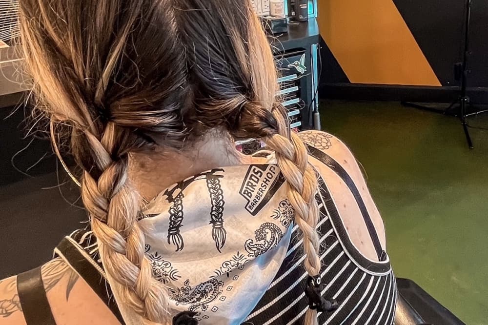 Haircuts can be upgraded with a complimentary braid add-on and a free Willie Nelson-inspired bandana. (Courtesy Birds Barbershop)
