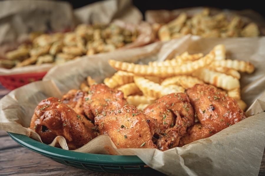 Chicken wings ($13.95)• are served with sauce or Cajun dry rub and fries. (Courtesy Andy's Bar & Grill) 