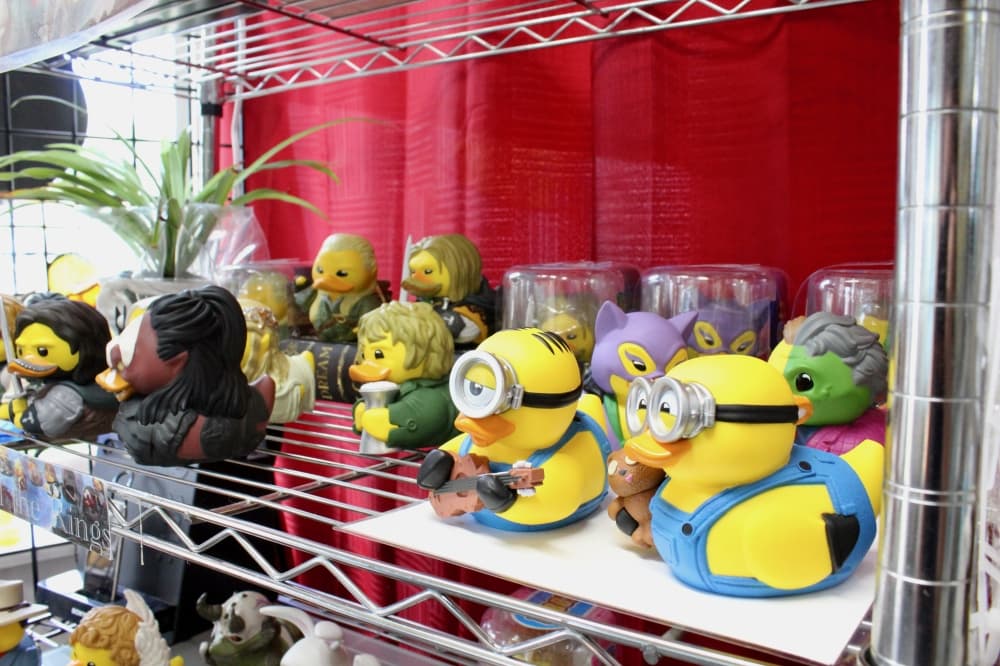 The photo shows a display shelf at Connie's Bath Shack with rubber ducks.