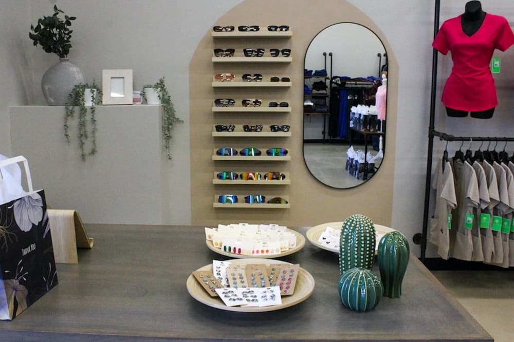 Hays Uniforms sells a variety of scrubs, workwear, sunglasses and earrings. (Amira Van Leeuwen/Community Impact)