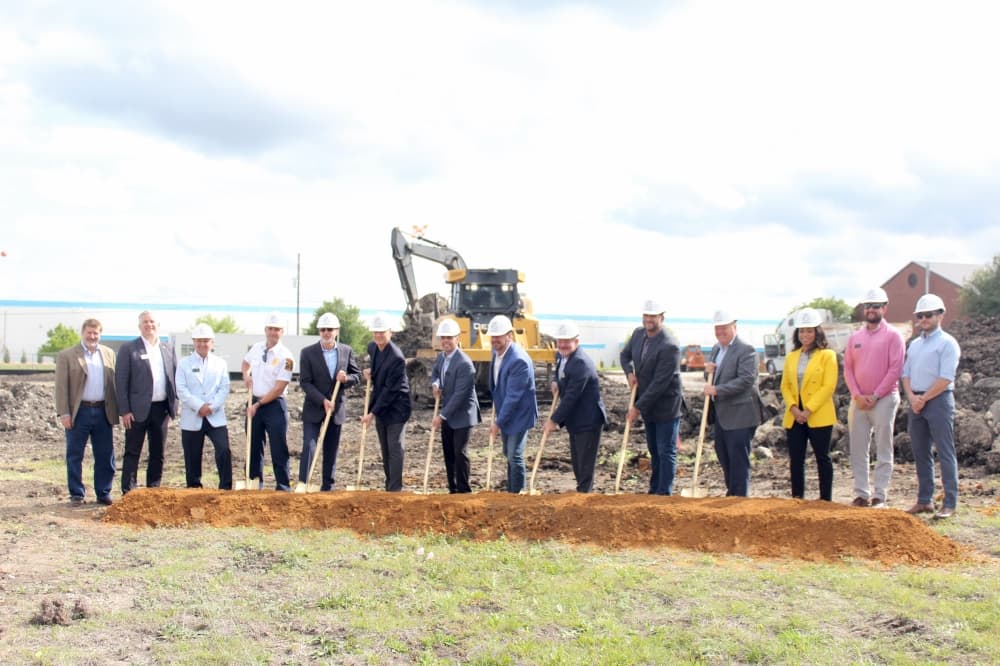 City leaders and Cirrus employees with shovels and dirt
